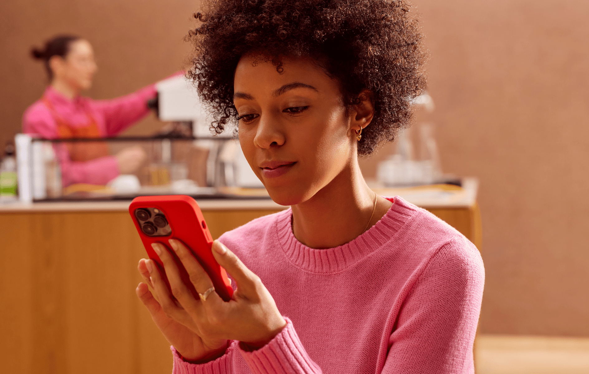 A woman using a smartphone in a cafe